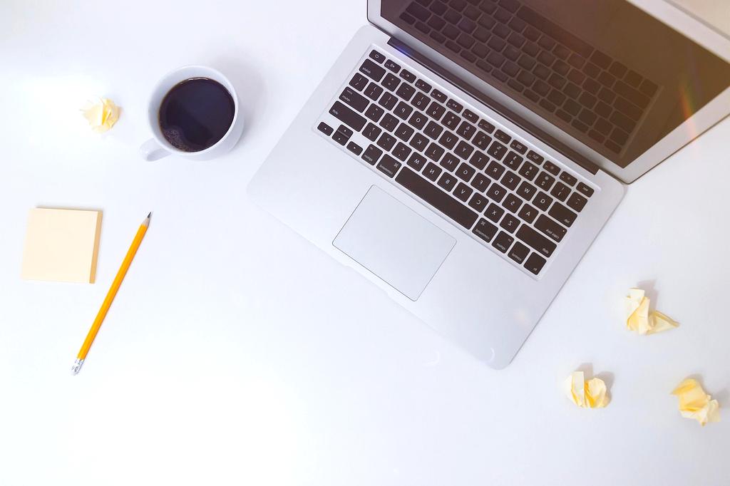 Notebook with motivational quotes and coffee cup