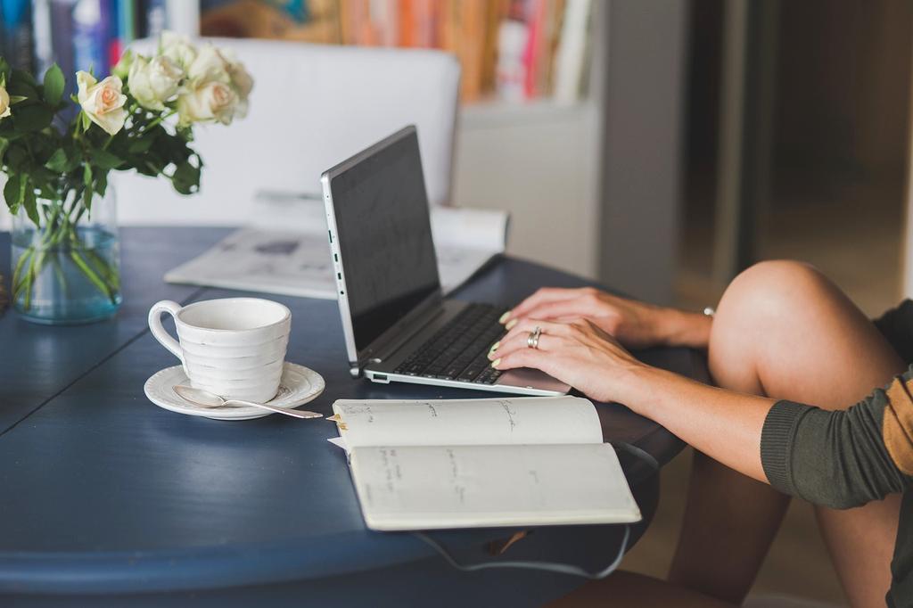 Open book and laptop with resource materials on desk